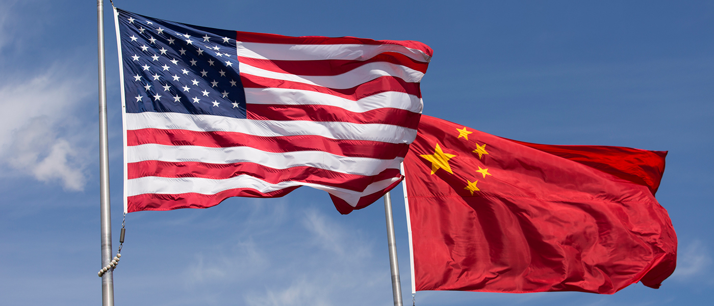 U.S. and chinese flags waving in the wind