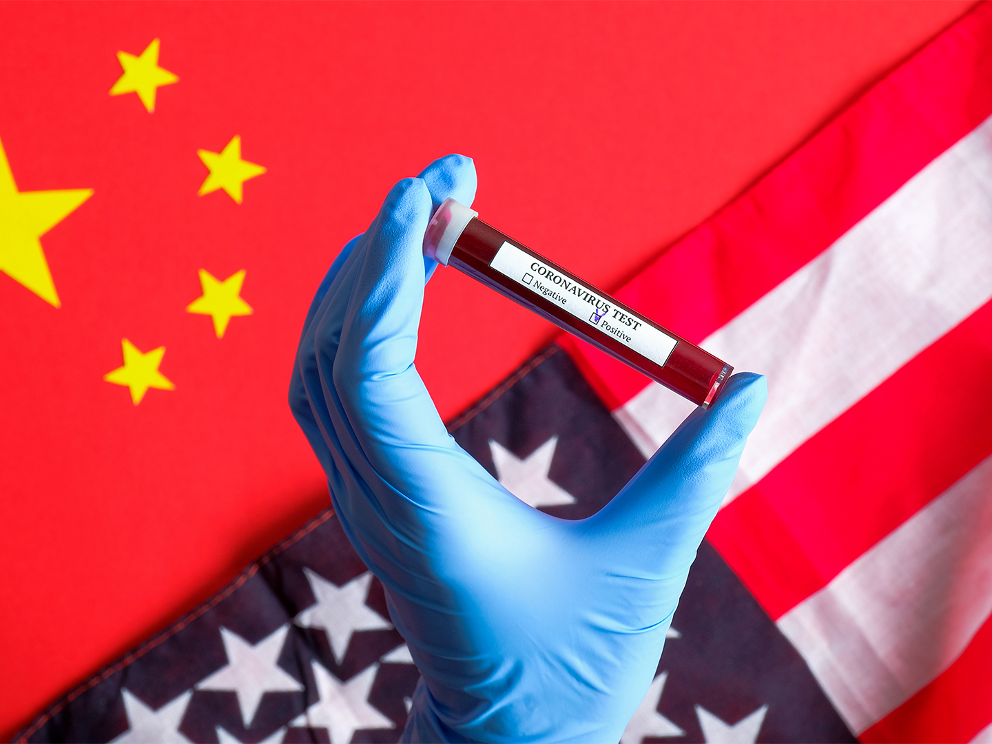 coronavirus vile in front of U.S. and Chinese flags