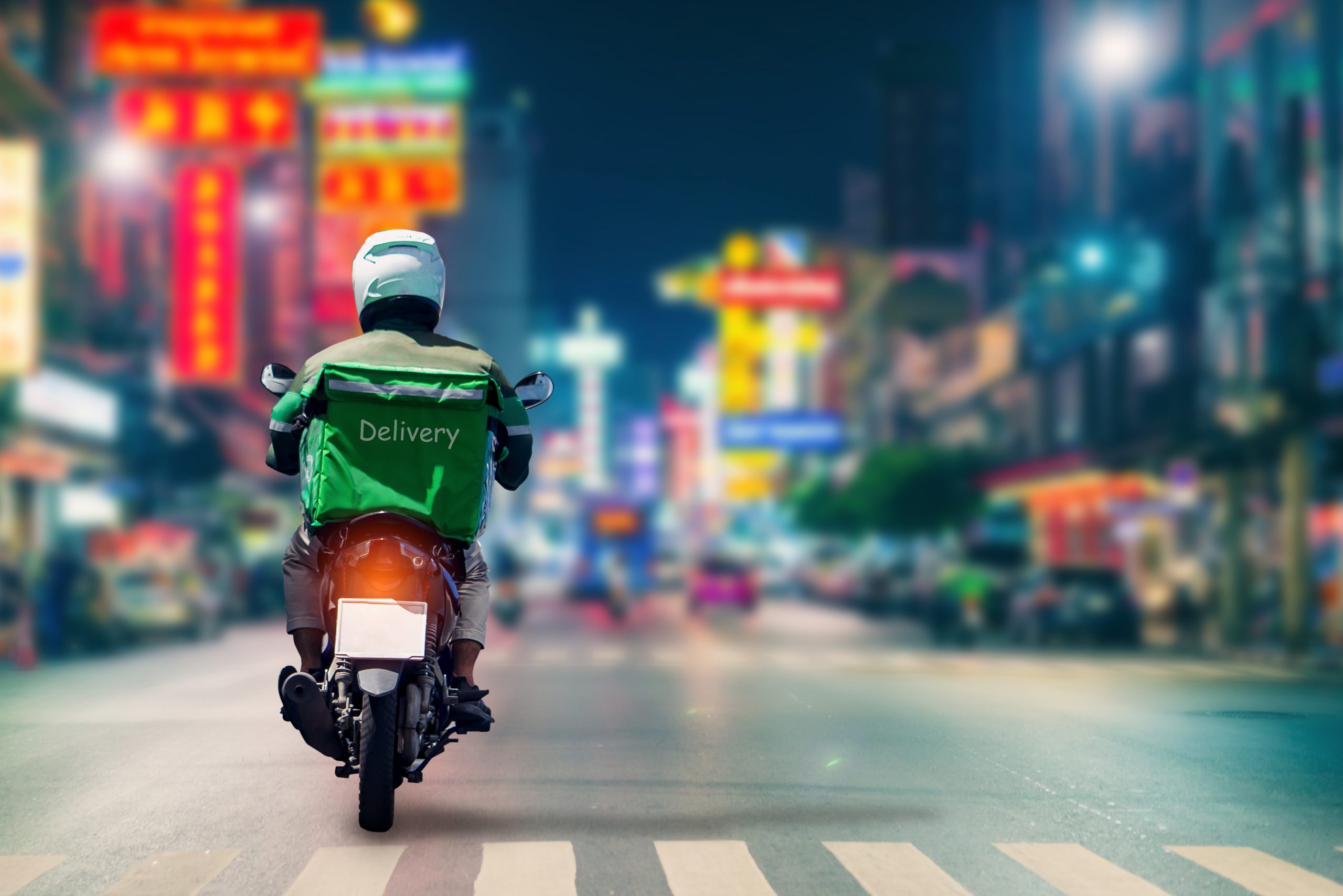 Man on Motorbike delivers products to customers who ordered online